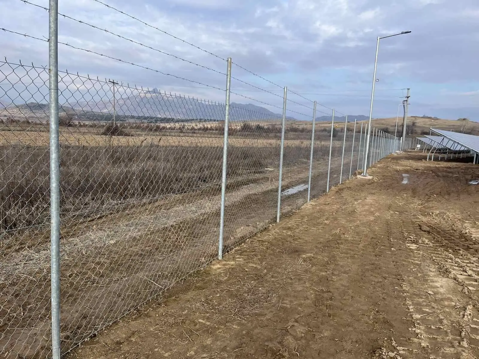 Fence line beside a solar array