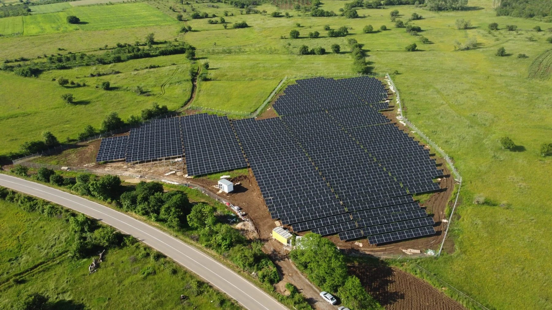 Solar arrays surrounded by green fields
