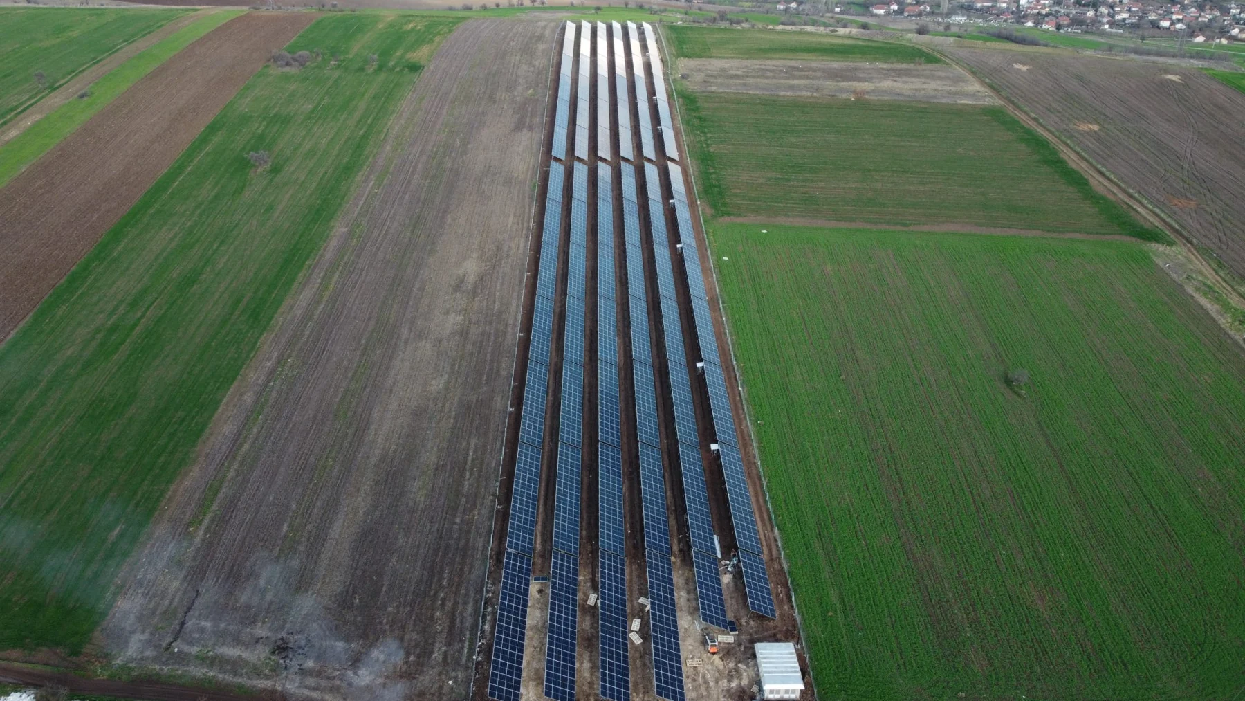 Rows of photovoltaic panels alongside fields