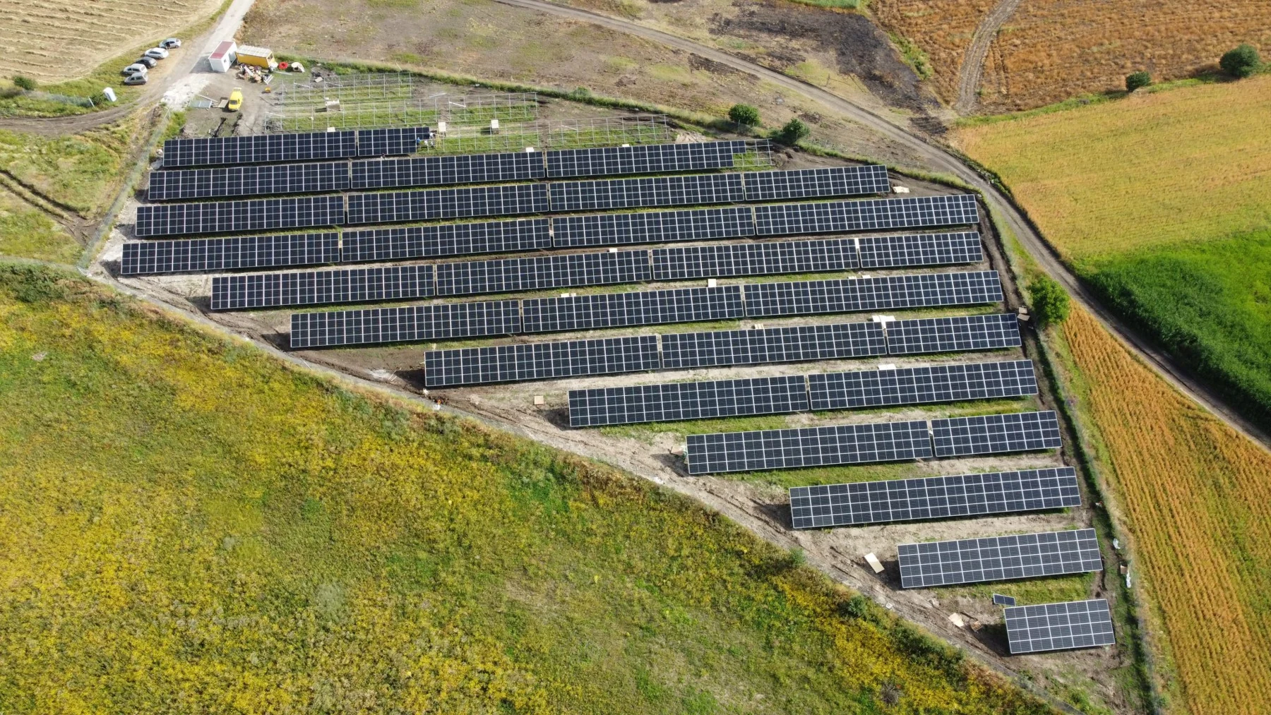 Photovoltaic rows across a hillside